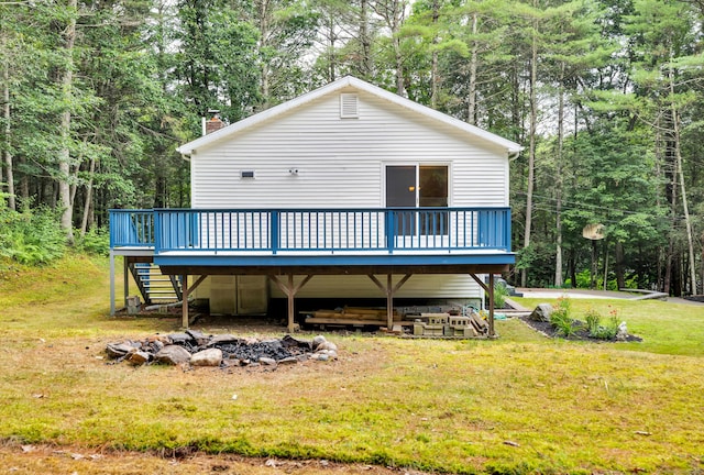 216 Old Monson Rd, Stafford, CT 06076 - rear view of property with an outdoor fire pit, a wooden deck, a lawn, stairway, and a chimney