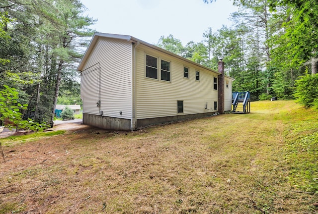 216 Old Monson Rd, Stafford, CT 06076 - view of home's exterior featuring a lawn, a chimney, and stairway