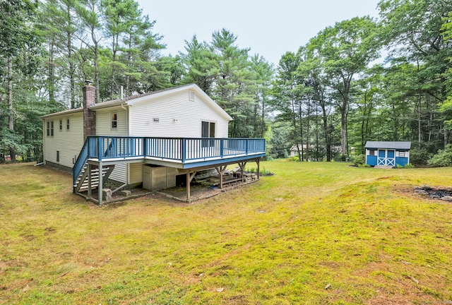 216 Old Monson Rd, Stafford, CT 06076 - rear view of property featuring stairs, a deck, a chimney, view of wooded area, and a lawn