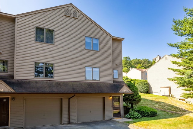 489 Wolcott St Unit 65, Bristol, CT 06010 - view of front of property with an attached garage, driveway, a front yard, and roof with shingles