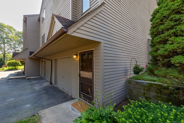 489 Wolcott St Unit 65, Bristol, CT 06010 - view of side of property featuring a garage