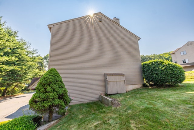 489 Wolcott St Unit 65, Bristol, CT 06010 - view of side of property with a chimney and a yard