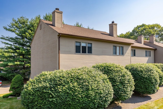 489 Wolcott St Unit 65, Bristol, CT 06010 - view of home's exterior with a chimney