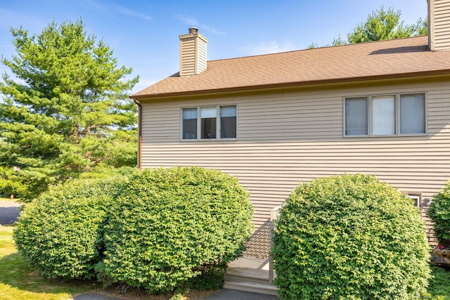 489 Wolcott St Unit 65, Bristol, CT 06010 - view of side of home featuring a chimney