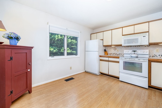 489 Wolcott St Unit 65, Bristol, CT 06010 - kitchen with white appliances, light wood-type flooring, tasteful backsplash, and light countertops