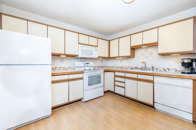 489 Wolcott St Unit 65, Bristol, CT 06010 - kitchen with white appliances, light wood finished floors, tasteful backsplash, and light countertops