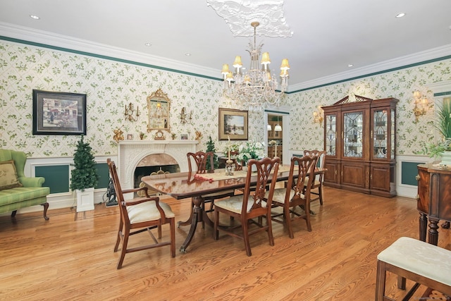 63 Turney Rd, Redding, CT 06896 - dining space featuring a chandelier, wainscoting, wallpapered walls, ornamental molding, and light wood-style flooring