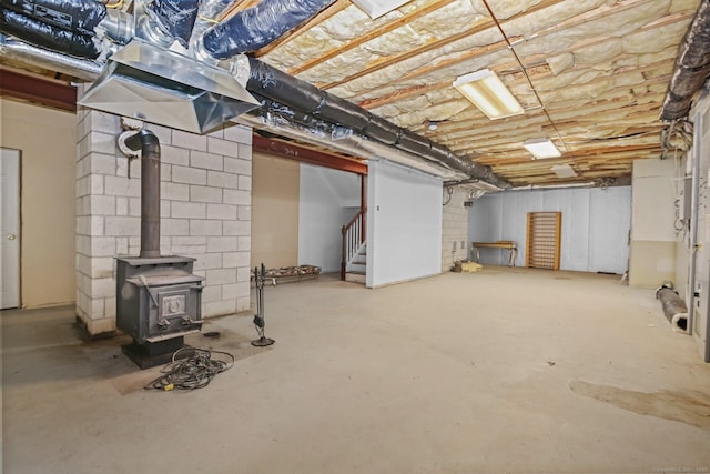 63 Turney Rd, Redding, CT 06896 - unfinished below grade area with stairs and a wood stove