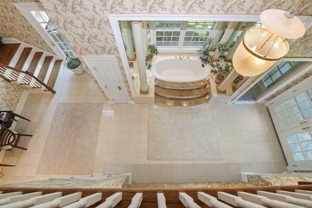 63 Turney Rd, Redding, CT 06896 - bathroom featuring wallpapered walls, a bath, healthy amount of natural light, and tile walls