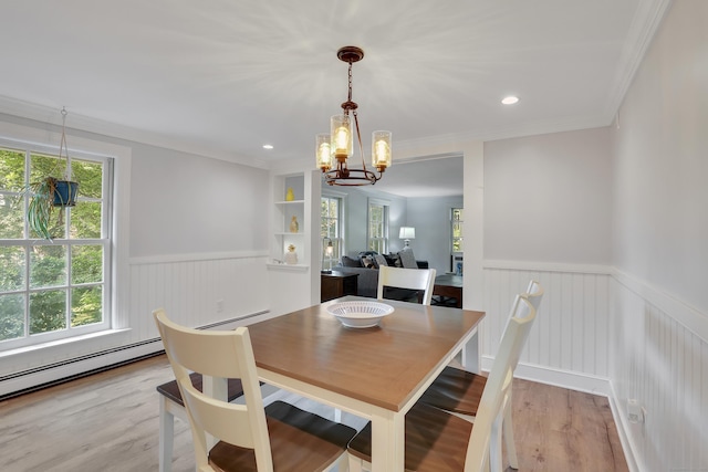202 Plainville Ave, Farmington, CT 06085 - dining room featuring a wainscoted wall, plenty of natural light, a chandelier, light wood finished floors, and a baseboard radiator