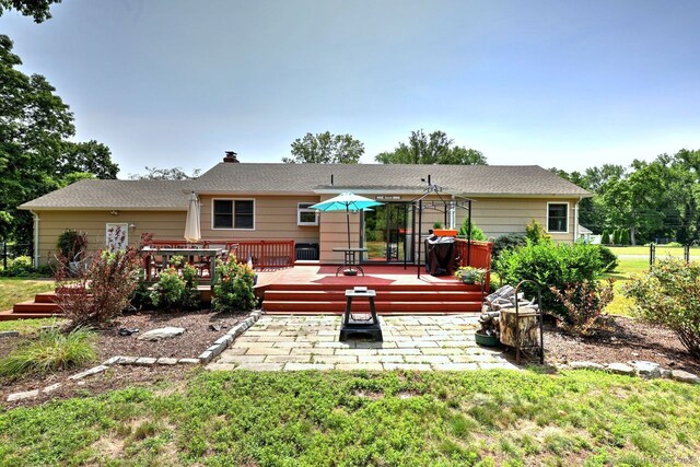 754 Riverside Dr, Orange, CT 06477 - back of property with a deck and a chimney
