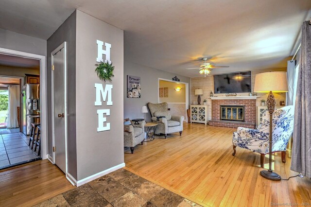 754 Riverside Dr, Orange, CT 06477 - living room with a ceiling fan, a fireplace, and wood finished floors