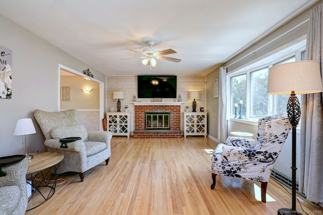 754 Riverside Dr, Orange, CT 06477 - living room featuring ceiling fan, wood finished floors, a brick fireplace, and wood walls