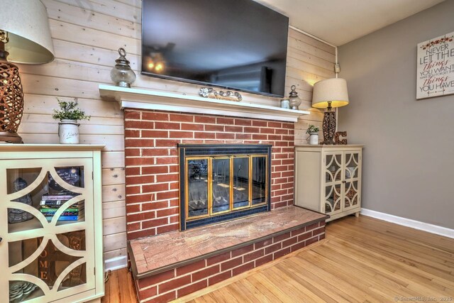 754 Riverside Dr, Orange, CT 06477 - detailed view of wooden walls, a brick fireplace, and wood finished floors
