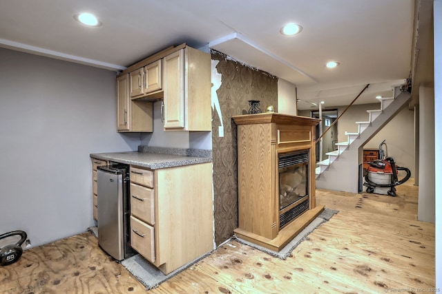 754 Riverside Dr, Orange, CT 06477 - kitchen with a glass covered fireplace, light brown cabinetry, light wood-style flooring, recessed lighting, and refrigerator