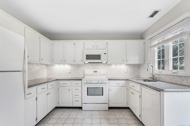 118 Grove St Apt 7, Stamford, CT 06901 - kitchen with white appliances, white cabinets, and decorative backsplash