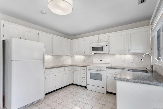 118 Grove St Apt 7, Stamford, CT 06901 - kitchen featuring white appliances, white cabinets, stone countertops, and tasteful backsplash