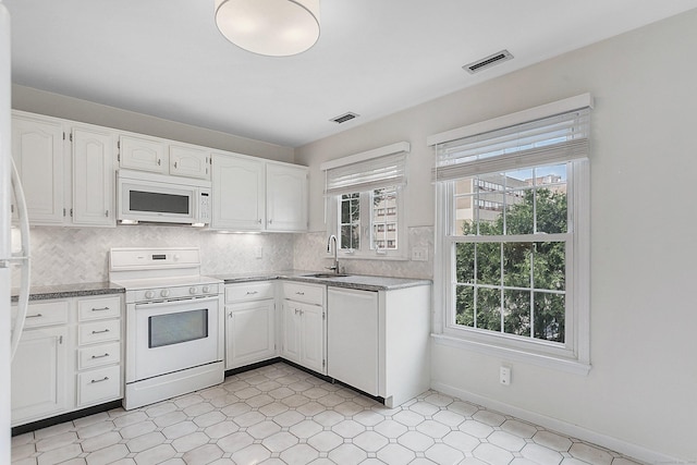 118 Grove St Apt 7, Stamford, CT 06901 - kitchen with white appliances, white cabinets, tasteful backsplash, and light floors