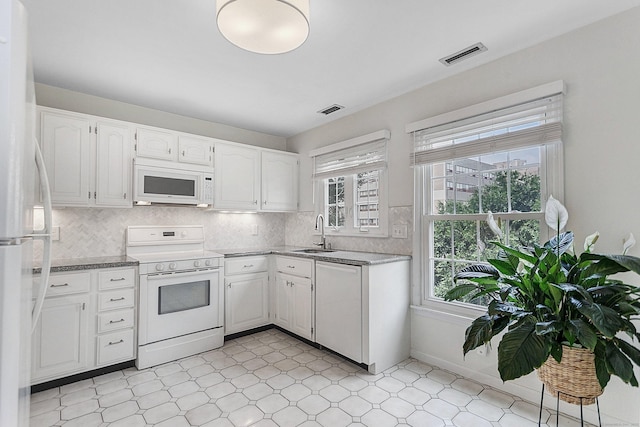 118 Grove St Apt 7, Stamford, CT 06901 - kitchen with white appliances, plenty of natural light, light flooring, and white cabinetry