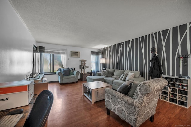 34 Woodland Dr Unit 34, Cromwell, CT 06416 - living area featuring dark wood-type flooring, a textured ceiling, a wall unit AC, and an accent wall