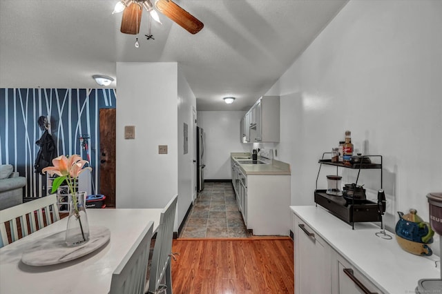 34 Woodland Dr Unit 34, Cromwell, CT 06416 - kitchen with freestanding refrigerator, light countertops, ceiling fan, light wood-type flooring, and gray cabinets