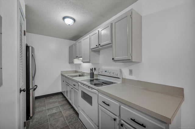 34 Woodland Dr Unit 34, Cromwell, CT 06416 - kitchen featuring white electric range, a textured ceiling, freestanding refrigerator, light countertops, and stone finish floors