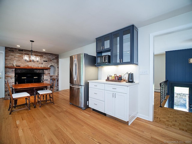 481 Gaylord Mountain Rd, Hamden, CT 06518 - kitchen with freestanding refrigerator, light wood-style floors, glass insert cabinets, baseboard heating, and recessed lighting