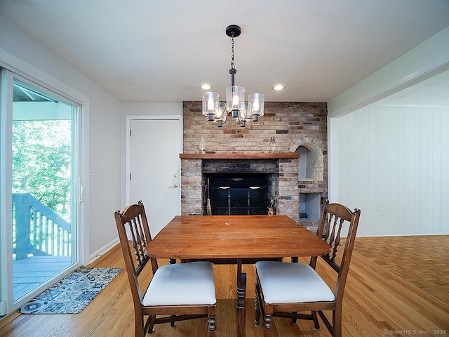 481 Gaylord Mountain Rd, Hamden, CT 06518 - dining room featuring a chandelier, light wood-style flooring, and a brick fireplace