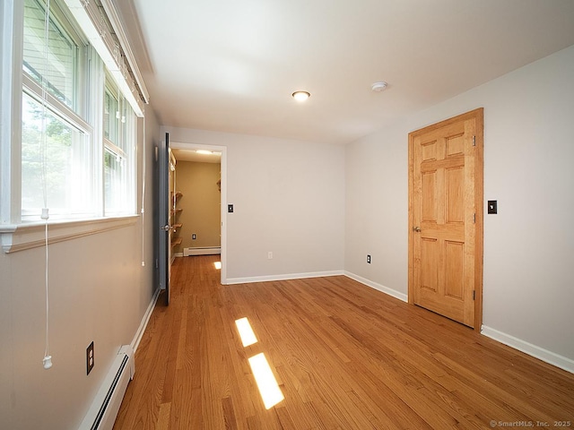 481 Gaylord Mountain Rd, Hamden, CT 06518 - empty room with a baseboard radiator, light wood-style floors, and a smoke detector