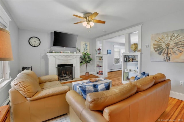 146 Summit St, Manchester, CT 06040 - living room featuring a baseboard heating unit, a fireplace, ceiling fan, and light wood-type flooring