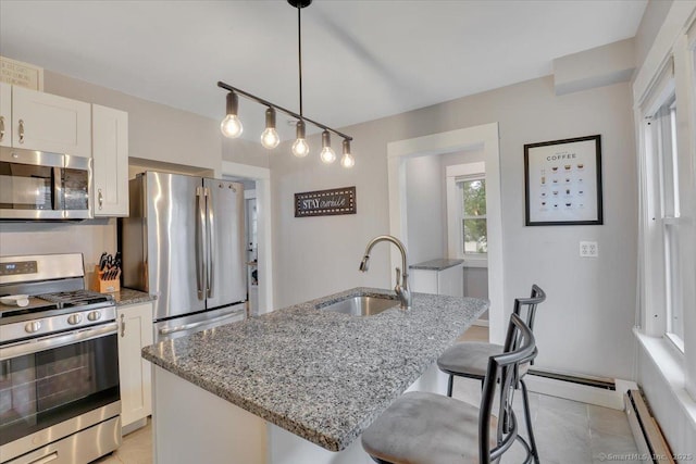 146 Summit St, Manchester, CT 06040 - kitchen featuring stainless steel appliances, a baseboard heating unit, light stone counters, a kitchen breakfast bar, and white cabinetry