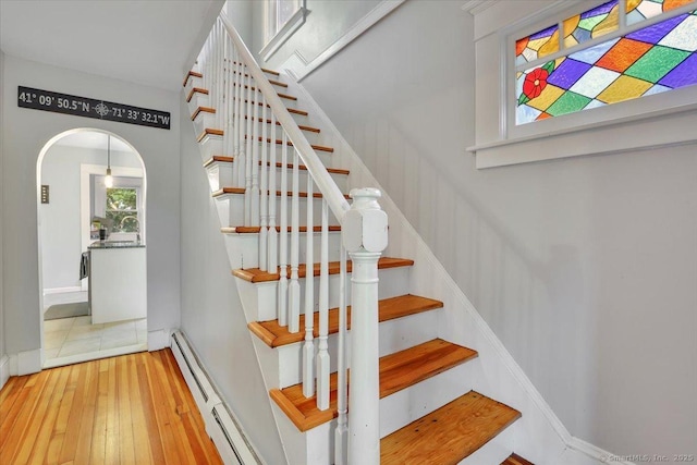 146 Summit St, Manchester, CT 06040 - staircase with a baseboard heating unit, hardwood / wood-style floors, and arched walkways