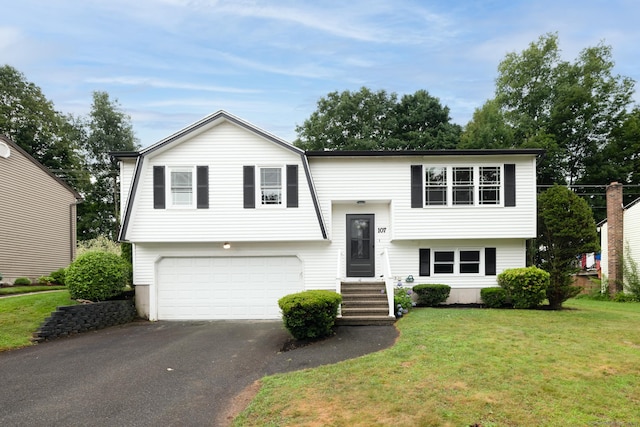 107 Meetinghouse Rdg, Meriden, CT 06450 - raised ranch with driveway, an attached garage, and a front yard