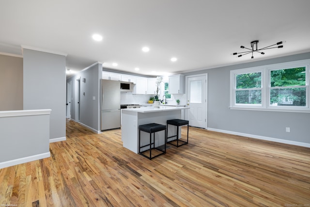 107 Meetinghouse Rdg, Meriden, CT 06450 - kitchen with white appliances, crown molding, a kitchen island, recessed lighting, and light wood-type flooring