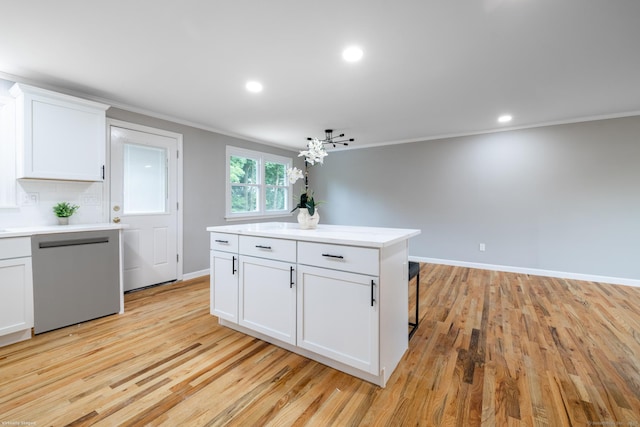 107 Meetinghouse Rdg, Meriden, CT 06450 - kitchen featuring stainless steel dishwasher, ornamental molding, light countertops, white cabinetry, and light wood-style floors