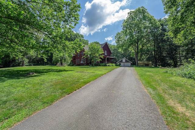 285 E St, Stafford, CT 06076 - view of front of house with a detached garage, a front lawn, and an outdoor structure