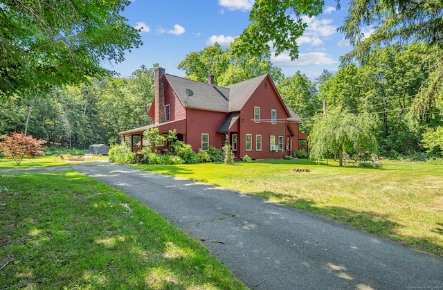 285 E St, Stafford, CT 06076 - view of front of home featuring a chimney, a front lawn, and a fire pit
