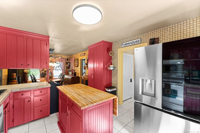 285 E St, Stafford, CT 06076 - kitchen with red cabinetry, light tile patterned floors, butcher block counters, and stainless steel fridge with ice dispenser