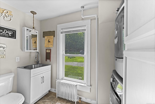 285 E St, Stafford, CT 06076 - bathroom with radiator, stacked washer / drying machine, and vanity