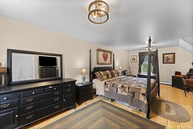 285 E St, Stafford, CT 06076 - bedroom featuring a baseboard radiator, hardwood / wood-style floors, and a chandelier