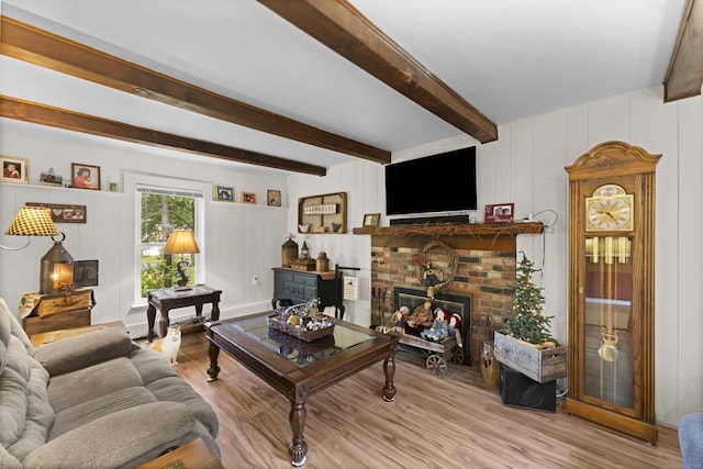 285 E St, Stafford, CT 06076 - living area featuring a fireplace, wood finished floors, beamed ceiling, and a decorative wall
