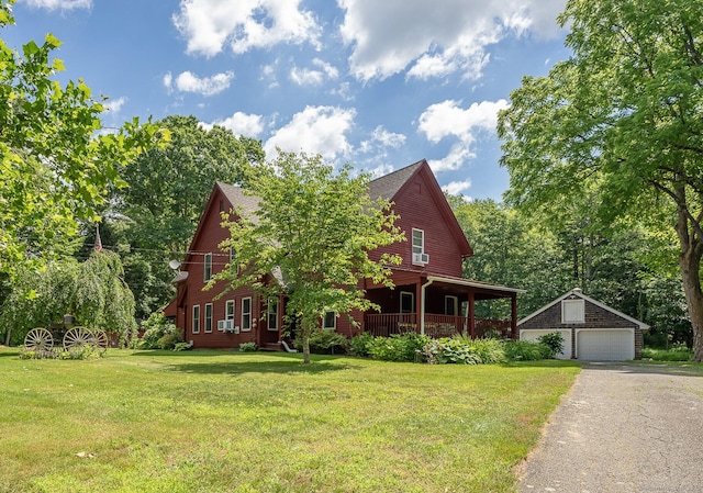 285 E St, Stafford, CT 06076 - view of front of house with a detached garage, an outdoor structure, and a front lawn