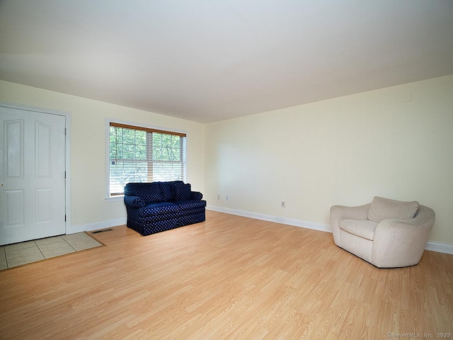 128 Briar Ln Unit 128, Norwich, CT 06360 - sitting room with light wood finished floors and baseboards