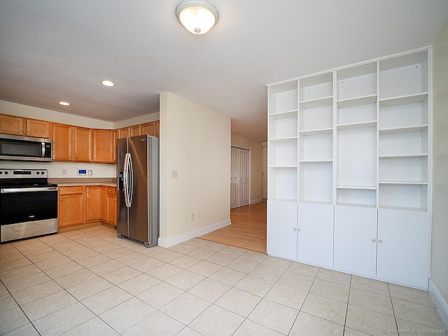 128 Briar Ln Unit 128, Norwich, CT 06360 - kitchen with appliances with stainless steel finishes, recessed lighting, light tile patterned flooring, and light countertops