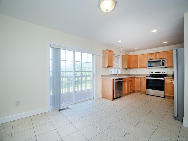 128 Briar Ln Unit 128, Norwich, CT 06360 - kitchen with stainless steel appliances, light countertops, light tile patterned floors, and recessed lighting