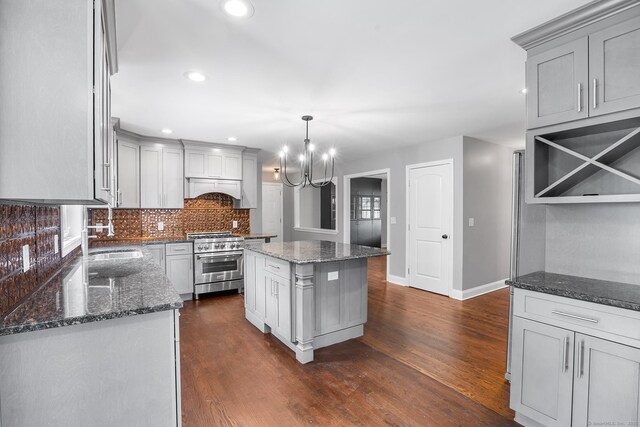 5 Evas Ter, Wolcott, CT 06716 - kitchen with high end stainless steel range oven, a chandelier, decorative backsplash, custom exhaust hood, and dark wood-style floors