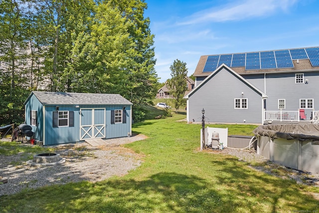 5 Evas Ter, Wolcott, CT 06716 - view of green lawn featuring an outdoor fire pit, a storage unit, and a covered pool