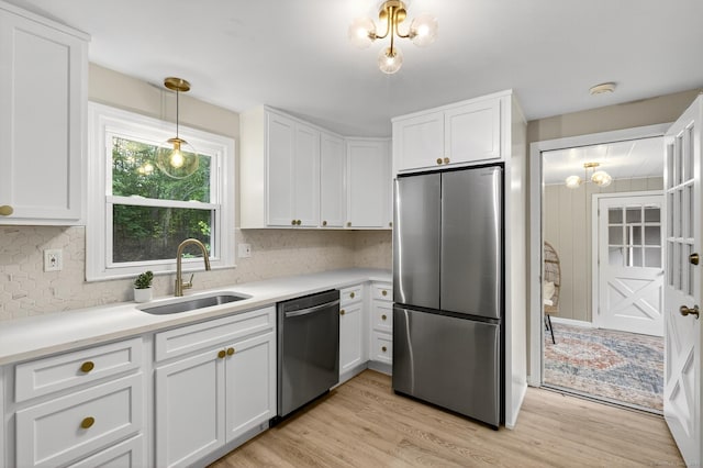 29 Bradford Dr, Windsor, CT 06095 - kitchen with appliances with stainless steel finishes, decorative backsplash, white cabinetry, and light wood-style flooring