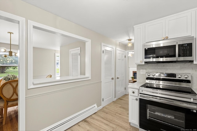 29 Bradford Dr, Windsor, CT 06095 - kitchen with appliances with stainless steel finishes, a baseboard heating unit, light wood finished floors, and white cabinetry