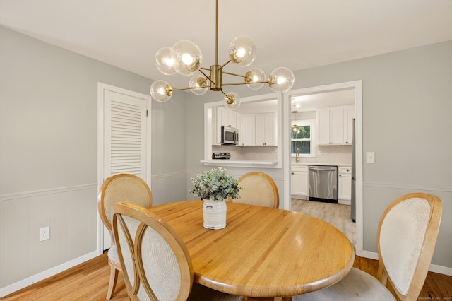 29 Bradford Dr, Windsor, CT 06095 - dining space with a chandelier, light wood finished floors, and wainscoting